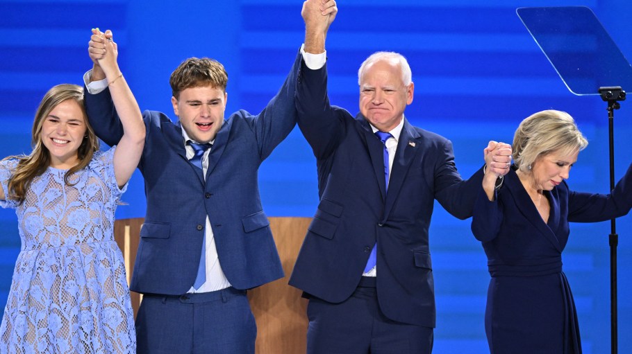 Minnesota Governor and Democratic vice presidential candidate Tim Walz stands onstage with his daughter Hope (L), son Gus (2L) and wife Gwen Walz (R) after he spoke on the third day of the Democratic National Convention (DNC) at the United Center in Chicago, Illinois.