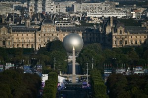 This photograph taken from the Arc de Triomphe shows the Paralympic cauldron with the Obelisque de Louxor (Luxor Obelisk) in front and the Louvre museum in the back ahead of the Paris 2024 Paralympic Games Opening Ceremony in Paris on August 28, 2024.