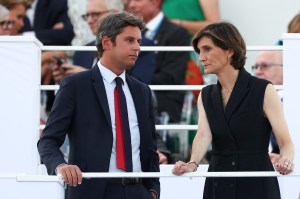 France's outgoing Prime Minister Gabriel Attal (L) stands next to France's outgoing Minister for Sports and Olympics Amelie Oudea-Castera (R) at the Place de la Concorde ahead of the Paris 2024 Paralympic Games Opening Ceremony in Paris on August 28, 2024.