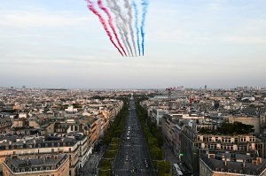 This photograph taken from the Arc de Triomphe shows French Air Force Elite acrobatic flying team "Patrouille de France" performing over the Champs-Elysees avenue during the Paris 2024 Paralympic Games Opening Ceremony in Paris on August 28, 2024.