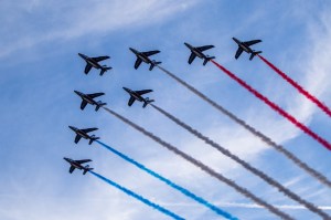 28 August 2024, France, Paris: Paralympics, Paris 2024, opening ceremony, Place de la Concorde. The French Air Force aerobatic team leaves contrails in the air in the colors of the French national flag.
