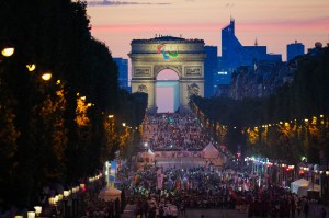 TOPSHOT - Athletes from different delegations parade on the Champs-Elysees avenue with the Arc de Triomphe in the background, during the Paris 2024 Paralympic Games Opening Ceremony in Paris on August 28, 2024.