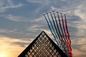 French Air Force Elite acrobatic flying team "Patrouille de France" performs over the Pyramide du Louvre designed by Chinese-US architect Ieoh Ming Pei, during the Paris 2024 Paralympic Games Opening Ceremony in Paris on August 28, 2024.