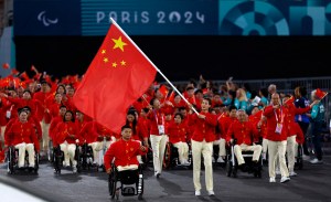 China's flagbearers and Paralympic athletes Haiyan Gu (C-R) and Yongkai Qi (C-L) during the Paris 2024 Paralympic Games Opening Ceremony in Paris on August 28, 2024.