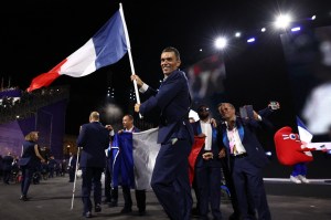 France's paralympic flag bearer Alexis Hanquinquant (C) parades at the Place de la Concorde during the Paris 2024 Paralympic Games Opening Ceremony in Paris on August 28, 2024.