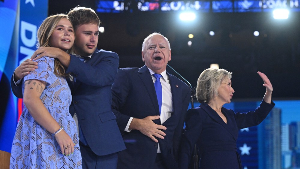 Democratic vice presidential nominee Minnesota Gov. Tim Walz celebrates with his daughter Hope Walz, son Gus Walz and wife Gwen Walz during the third day of the Democratic National Convention on Aug. 21 in Chicago, navy, Badgley Mischka