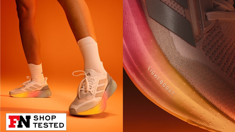 gray running sneakers with pink and yellow outsoles 