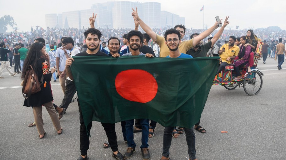 Anti-government protesters hold the Bangladeshi flag at the parliament house during the celebrations. Thousands of people celebrate the resignation of Bangladeshi Prime Minister Sheikh Hasina.