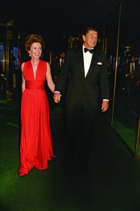 Govener Ronald Reagan holding hands with his wife Nancy as they arrive to the Governor's Dance at the Rainbow Room in New York