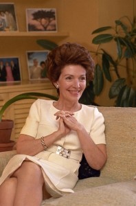First Lady of California, Nancy Reagan, smiling with hands clasped