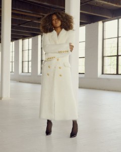 Schiaparelli ecru brushed wool and mohair coat embellished with hammered gold brass nipple bijoux buttons and gold thread signature measuring tape embroidery; Christian Louboutin pumps; Material Good Classic Diamond Tennis Necklace with Fancy Brown Diamond Drop in 18-karat white gold with 4.5 carats of fancy brown yellow diamond, 7.5 carats of round brilliant white diamonds; Chopard U.S. Exclusive Haute Joaillerie Collection earrings featuring 37.3 carats of sapphires and diamonds set in titanium.