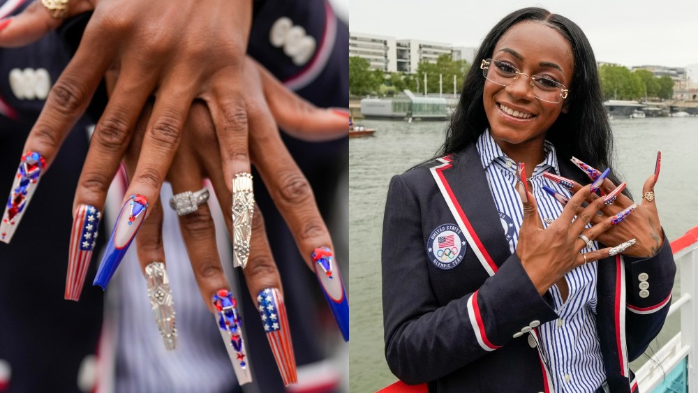 Sha'Carri Richardson, of the United States, shows off her nails while traveling along the Seine River in Paris during the opening ceremony of the 2024 Summer Olympics, Friday, July 26, 2024. 
