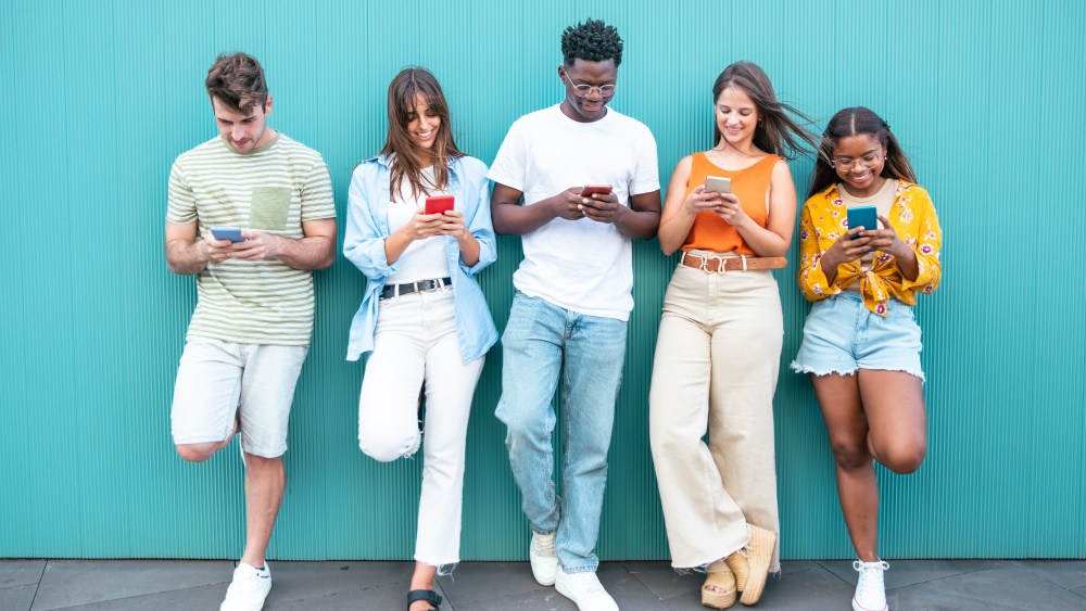 Group of fashion friends watching on their smart mobile phones - Millennial generation z addicted to new technology trends - Concept of youth lifestyle