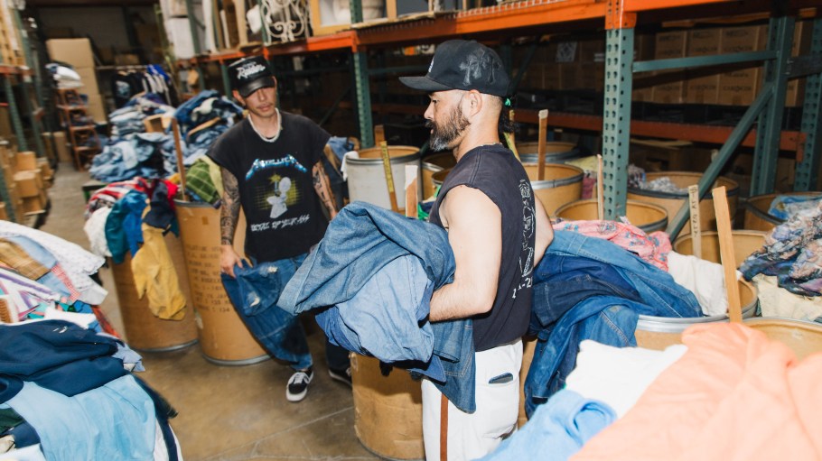 Designer sourcing garments at American Rag's warehouse.