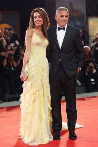 VENICE, ITALY - SEPTEMBER 01: Amal Clooney and George Clooney attend the "Wolfs" red carpet during the 81st Venice International Film Festival on September 01, 2024 in Venice, Italy. (Photo by Vittorio Zunino Celotto/Getty Images)