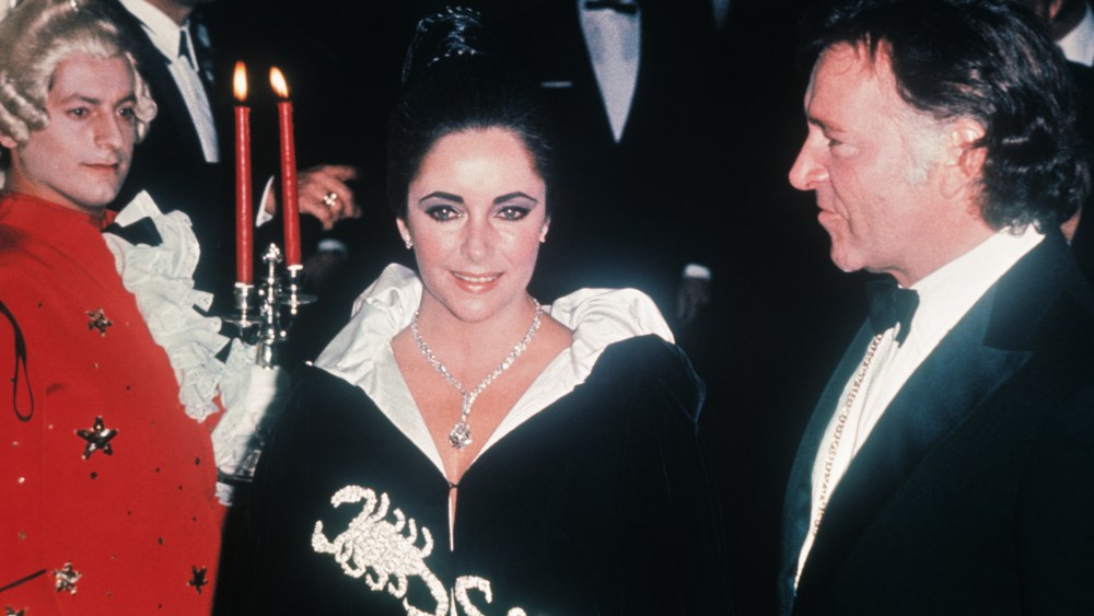 (Original Caption) Million Dollar Look: Monte Carlo: Liz Taylor positively glows with delight. Husband Richard Burton beams happily, and at Liz's throat sparkles a diamond worth one million dollars. It's the Cartier diamond Burton bought for his wife two weeks ago, getting its first airing this weekend at Princess Grace's birthday party in Monaco. Grace only invited people with the same Scorpio birth-sign as herself, but Liz was born under Pisces. Burton, fortunately is a Scorpio subject.