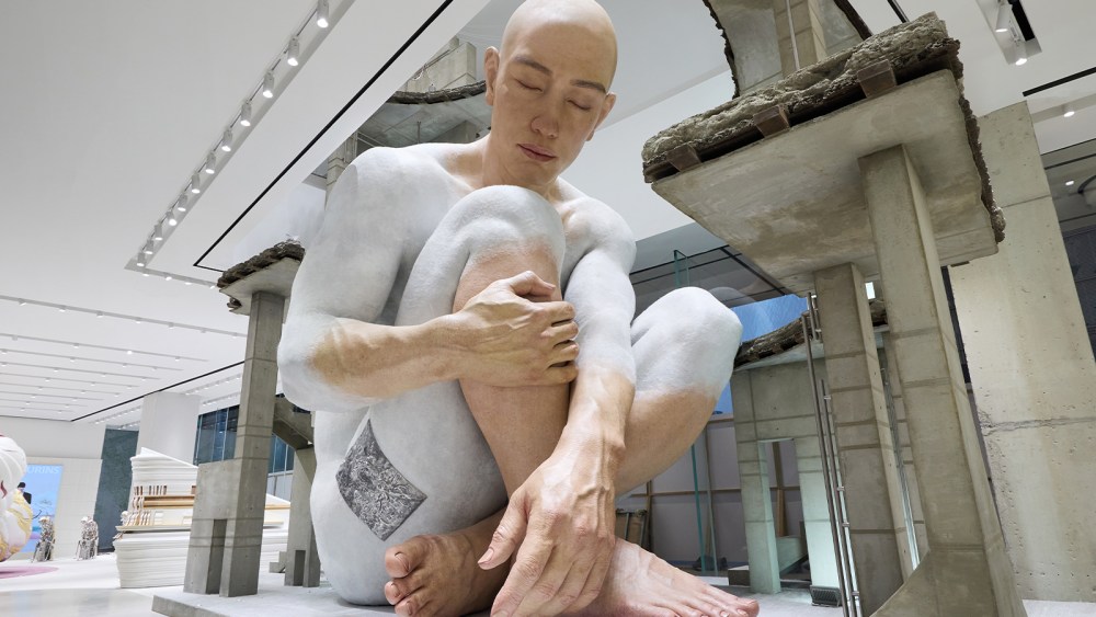 A larger-than-life sculpture called "The Colossal First Human" at the entrance of Haus Nowhere's Shenzhen store.