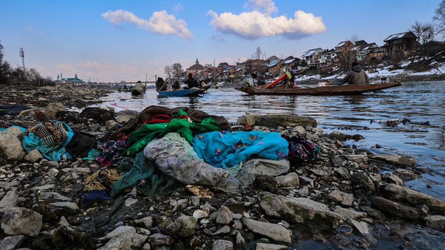 Used clothes thrown into the river Jhelum by local residents are creating pollution while a fisherman is catching fish in Sopore District, Baramulla, Jammu and Kashmir, India.