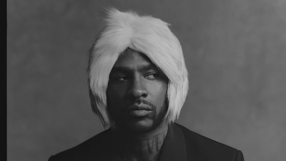 Skepta wearing one of the furry hats he plans to show as part of the Mains collection at London Fashion Week.