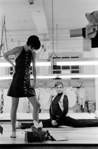 American fashion designer Betsey Johnson does the splits on the floor of her studio as an unidentified model poses in front of her, New York, New York, September 6, 1966. (Photo by Susan Wood/Getty Images)
