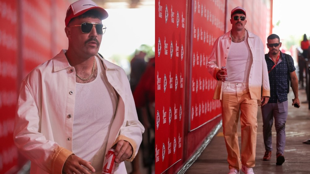 Travis Kelce #87 of the Kansas City Chiefs arrives before taking on the Baltimore Ravens, lavin outfit, Home Bred Legends trucker hat, paired with Bottega Veneta BV1012 sunglasses