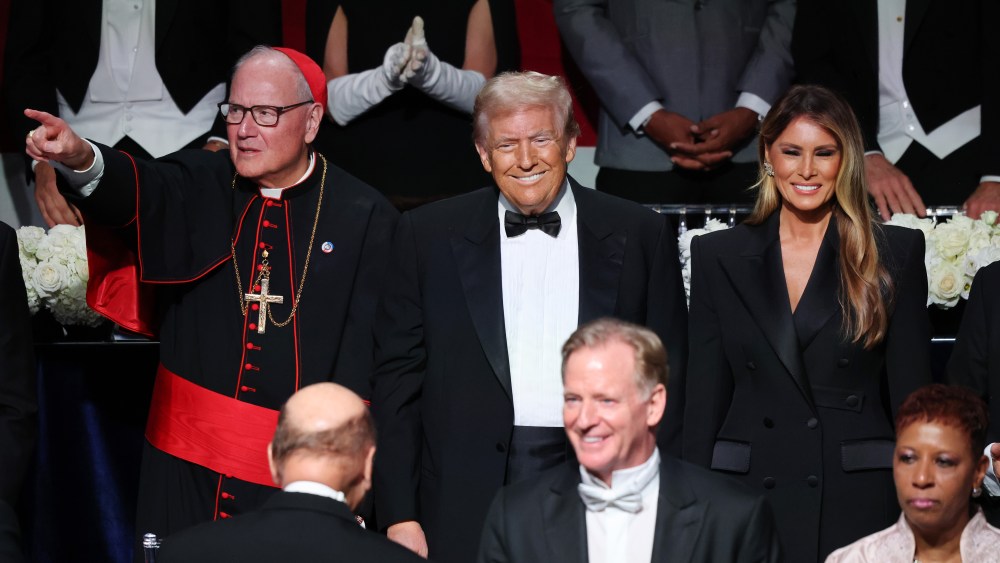 NEW YORK, NEW YORK - OCTOBER 17:  (L-R) Cardinal Timothy Dolan, Republican presidential nominee, former U.S. President Donald Trump and Melania Trump stand during the annual Alfred E. Smith Foundation Dinner at the New York Hilton Midtown on October 17, 2024 in New York City. Trump is scheduled to speak with comedian Jim Gaffigan as the Master of Ceremonies at the 79th Annual Alfred E. Smith Memorial Foundation Dinner. The dinner, a white-tie charity event that benefits Catholic charities, is known for political figures poking fun at one another. The foundation honors the late Alfred E. Smith, former governor of New York and America's first Catholic presidential nominee. (Photo by Michael M. Santiago/Getty Images)