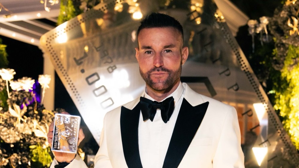 Philipp Plein shows holds the No Limit$ Platinum fragrance.