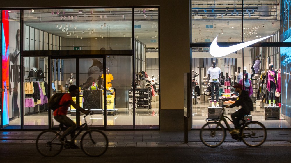 Cyclists ride past the Nike store in Antwerp, Belgium.