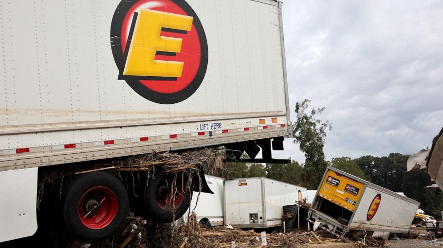 A view of flood damage to tractor trailers wrought by Hurricane Helene along the Swannanoa River on October 4, 2024 in Asheville, North Carolina. At least 215 people were killed in six states in the wake of the powerful hurricane which made landfall as a Category 4.