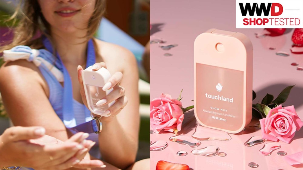 model spraying hand santizer on to another woman's hands; pink hand sanitizer bottle on pink table surrounded by roses