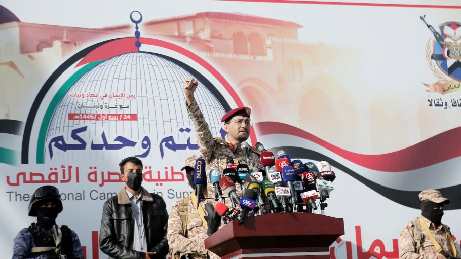 Houthi Military spokesperson Brigadier Yahya Sarea shouts slogans as he delivers a military statement during a protest staged against the Israeli aerial attacks on Lebanon, on September 27, 2024.