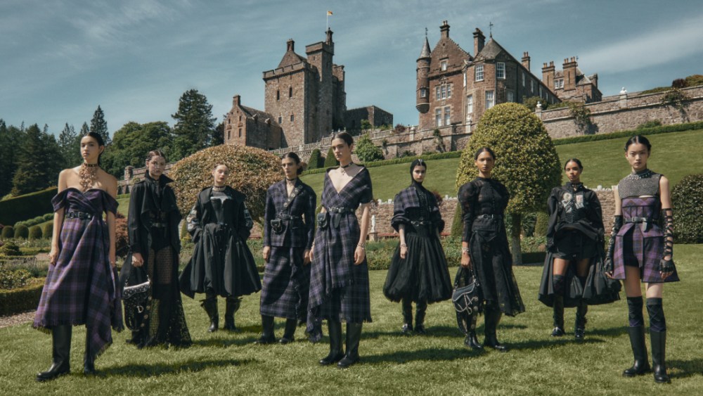 Models in looks from Dior's cruise 2025 collection pose in front of Drummond Castle, Scotland