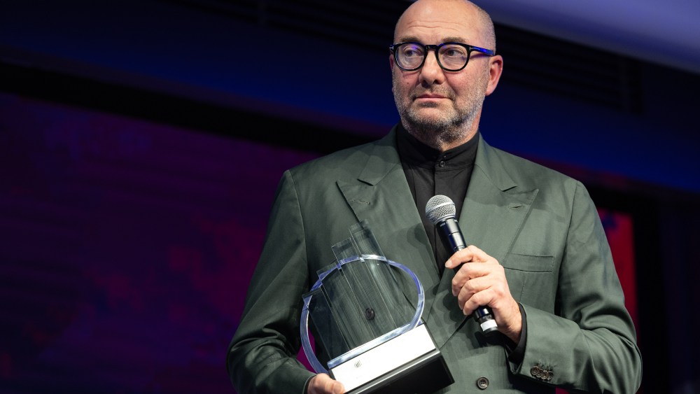 Davide Bollati, president of Italian beauty company Davines Group, receiving the EY award.