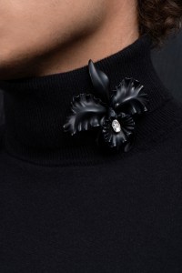 The black orchid brooch in white gold, silver, and antique oval-cut diamond. I love working on textures in each piece I create; here, you can see the contrast between the matte black patina and the bright sparkle of the diamond. I enjoy when there’s a real dialogue between the sculpture work and the gems I use.
