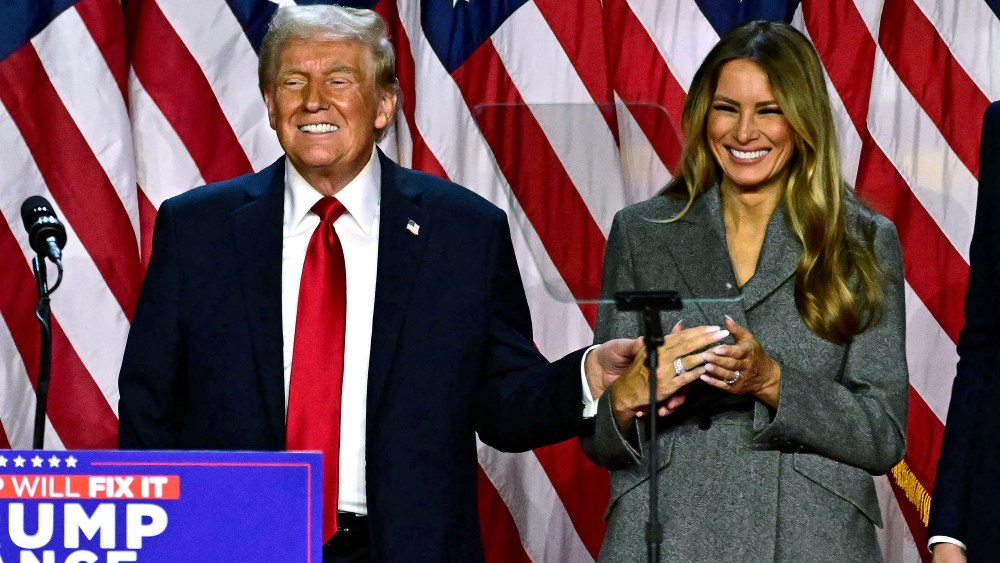 Former US President and Republican presidential candidate Donald Trump and former US First Lady Melania Trump smile after speaking during an election night event at the West Palm Beach Convention Center in West Palm Beach, Florida, early on November 6, 2024. Republican former president Donald Trump closed in on a new term in the White House early November 6, 2024, just needing a handful of electoral votes to defeat Democratic Vice President Kamala Harris.