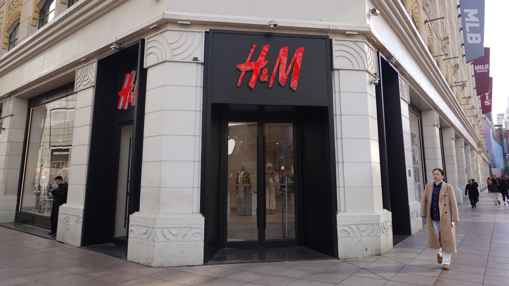 SHANGHAI, CHINA - NOVEMBER 27, 2024 - People walk past an H&M clothing store on Nanjing Road Pedestrian street in Shanghai, China, November 27, 2024. (Photo credit should read CFOTO/Future Publishing via Getty Images)