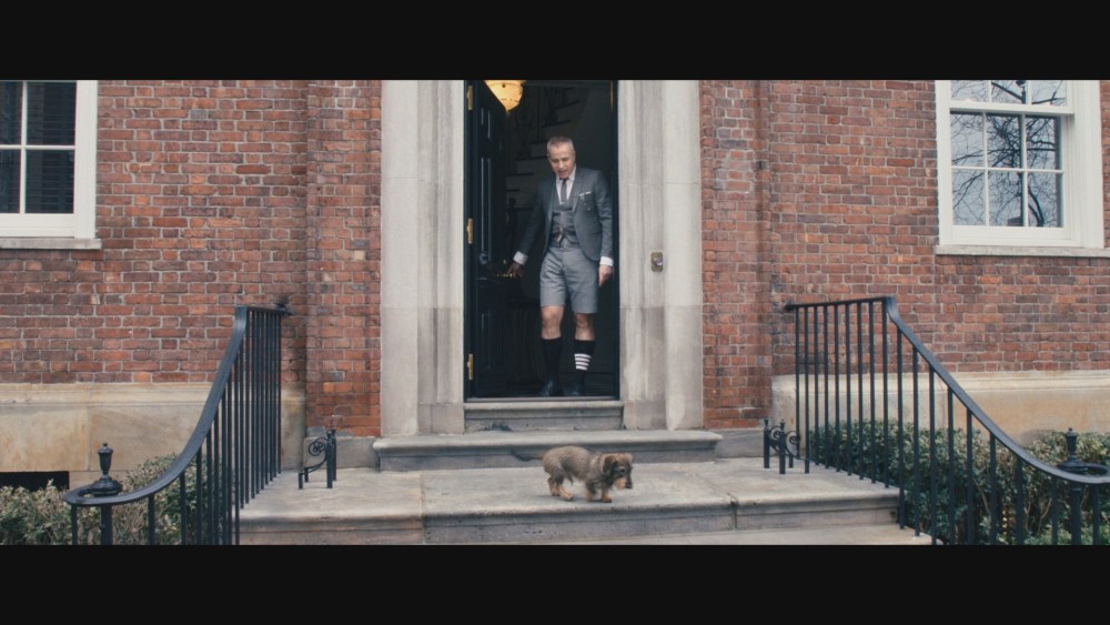 In a still from the film, Thom Browne and his dog Hector leave their home.