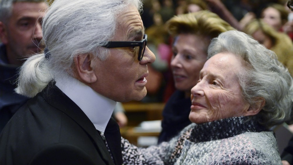 German fashion designer Karl Lagerfeld (L) meets Eliane Heilbronn, mother of the main Chanel shareholder, at the Institute of Political Studies (IEP) or "Sciences Po" before giving a master class on November 19, 2013 in Paris. AFP PHOTO / ERIC FEFERBERG via Getty Images