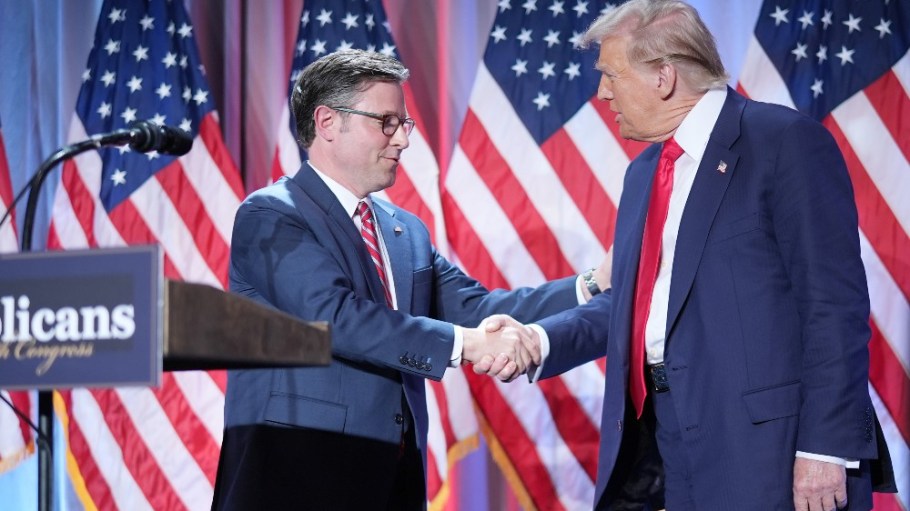 Speaker of the House Mike Johnson shakes hands with U.S. President-elect Donald Trump onstage at a House Republicans Conference meeting on Wednesday.