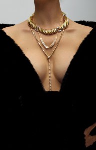 Apparis recycled polyester coat; Lugano yellow oval diamond lariat, oval-shaped yellow diamonds and round diamonds and set in 18-karat yellow gold; Briony Raymond Estate 18-karat yellow gold and diamond collar Nouvel heritage necklace; Nouvel Heritage Tuxedo Mood necklace in 18-karat yellow gold with diamonds photographed in New York, New York on November 19th, 2024.