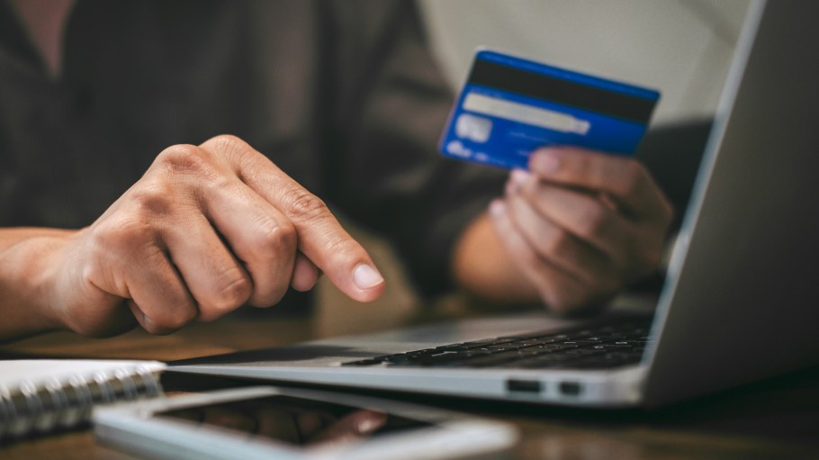 Businessman holding credit card and typing on laptop for online shopping and payment makes a purchase on the Internet, Online payment, Business financial and technology.