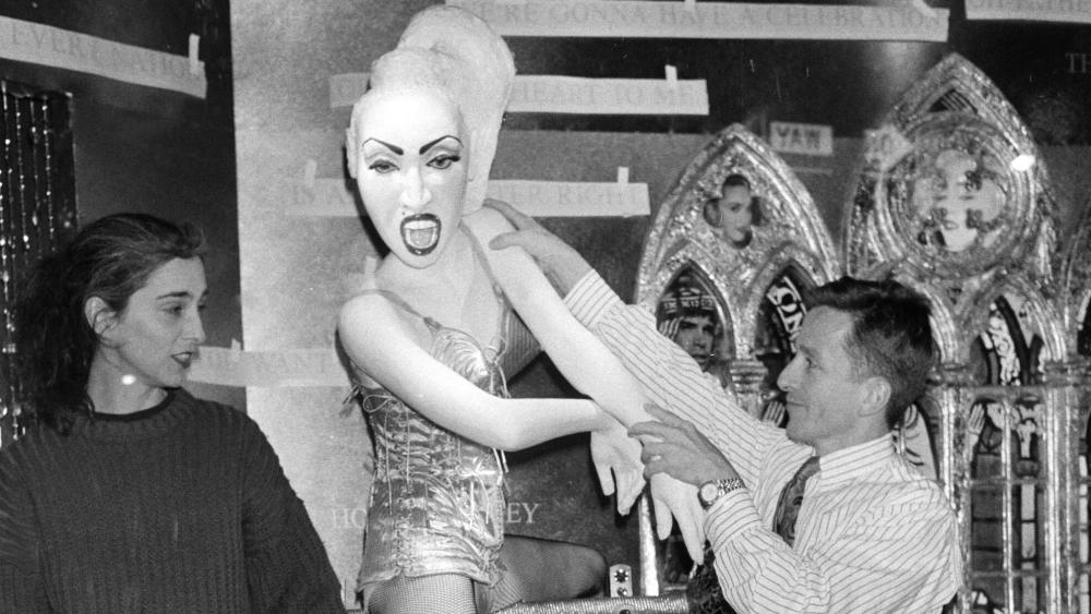Simon Doonan and a team member work on a Madonna sculpture in a Jean Paul Gaultier bustier for Barneys New York's 1990 holiday window display. 