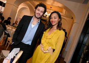 Adam Brody, Zoe Saldana at the Golden Globes First-Time Nominee Luncheon at Maybourne Beverly Hills on December 17, 2024 in Los Angeles, California.