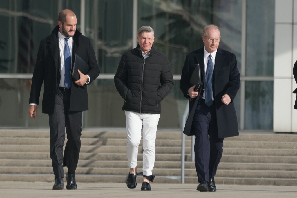 Matthew Smith (C), the partner of former Abercrombie & Fitch CEO, Mike Jeffries, exits after being arraigned in federal court, in Central Islip, New York, on December 3, 2024. Jeffries and Smith have been arrested and charged with running a prostitution and international sex trafficking operation. (Photo by Bryan R. SMITH / AFP) (Photo by BRYAN R. SMITH/AFP via Getty Images)