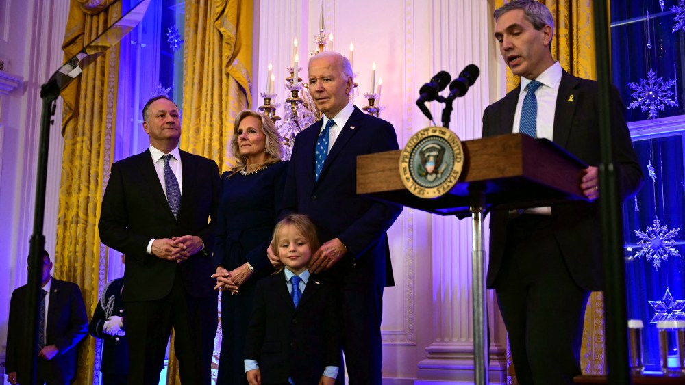 Second gentleman Doug Emhoff, first lady Jill Biden, President Joe Biden and his grandson Beau Biden Jr. listen to Rabbi Elliot Cosgrove during a Hanukkah holiday reception at the White House on Dec. 16 in Washington.