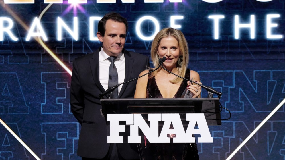 Ricardo Larroudé and Marina Larroude speak onstage during the Footwear News Achievement Awards (FNAAs) 2024 at Cipriani South Street on December 04, 2024 in New York City. (Photo by Craig Barritt/Footwear News via Getty Images)