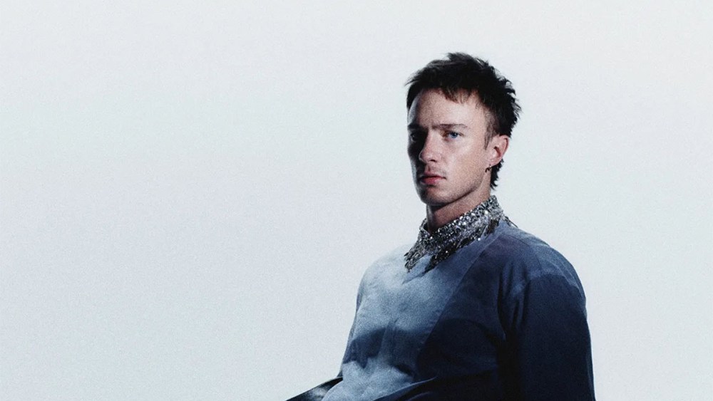 Drew Starkey. McQueen cotton poplin shirt chainmail and crystal embroidered stand collar; Willy Chavarria wool and cashmere trousers. Prada shoes.