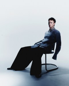 McQueen cotton poplin shirt chainmail and crystal embroidered stand collar; Willy Chavarria wool and cashmere trousers. Prada shoes.