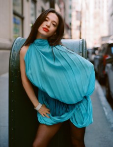 Alaïa asymmetrical pleated viscose dress and leather fringes belt; Van Cleef & Arpels Perlée diamonds cuff bracelet featuring diamonds set in 18-karat white gold.
