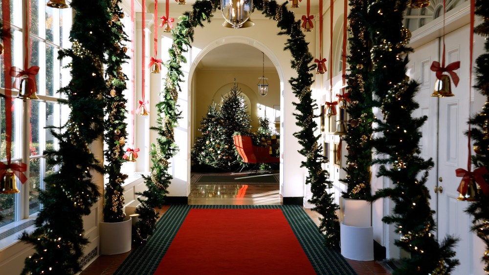 Brass-colored bells hang from the ceiling and sleigh bells line the archways of the East Colonnade during a media preview of the 2024 holiday decorations at the White House on December 02, 2024 in Washington, DC.